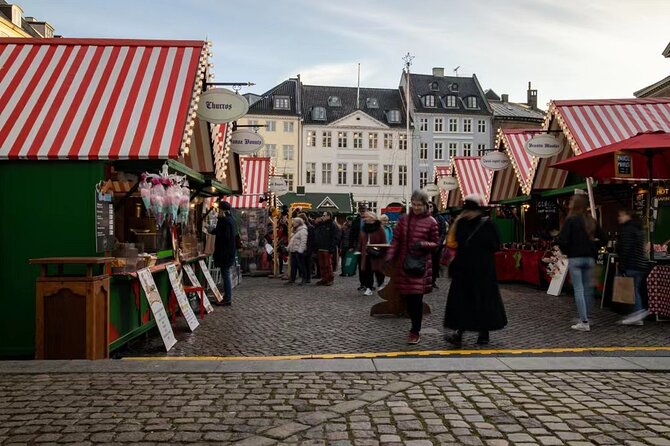 Copenhagen Private Christmas Walking Tour with Gløgg - Tivoli Gardens at dusk: spruce trees, fairy lights, and the 1994 Christmas market story
